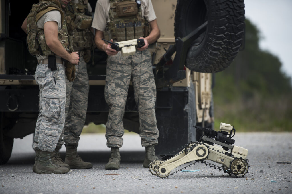 Staff Sgt. Brian Wirt shows two other 325th Fighter Wing Explosive Ordinance Disposal members how to operate a Micro Tactical Ground Robot (MTGR) before beginning a training exercise at Tyndall Air Force Base, Fla. The 20-pound MTGR is a tactical reconnaissance and surveillance robot which can maneuver in all terrains.  (U.S. Air Force photo/Staff Sgt. Andrew Lee)